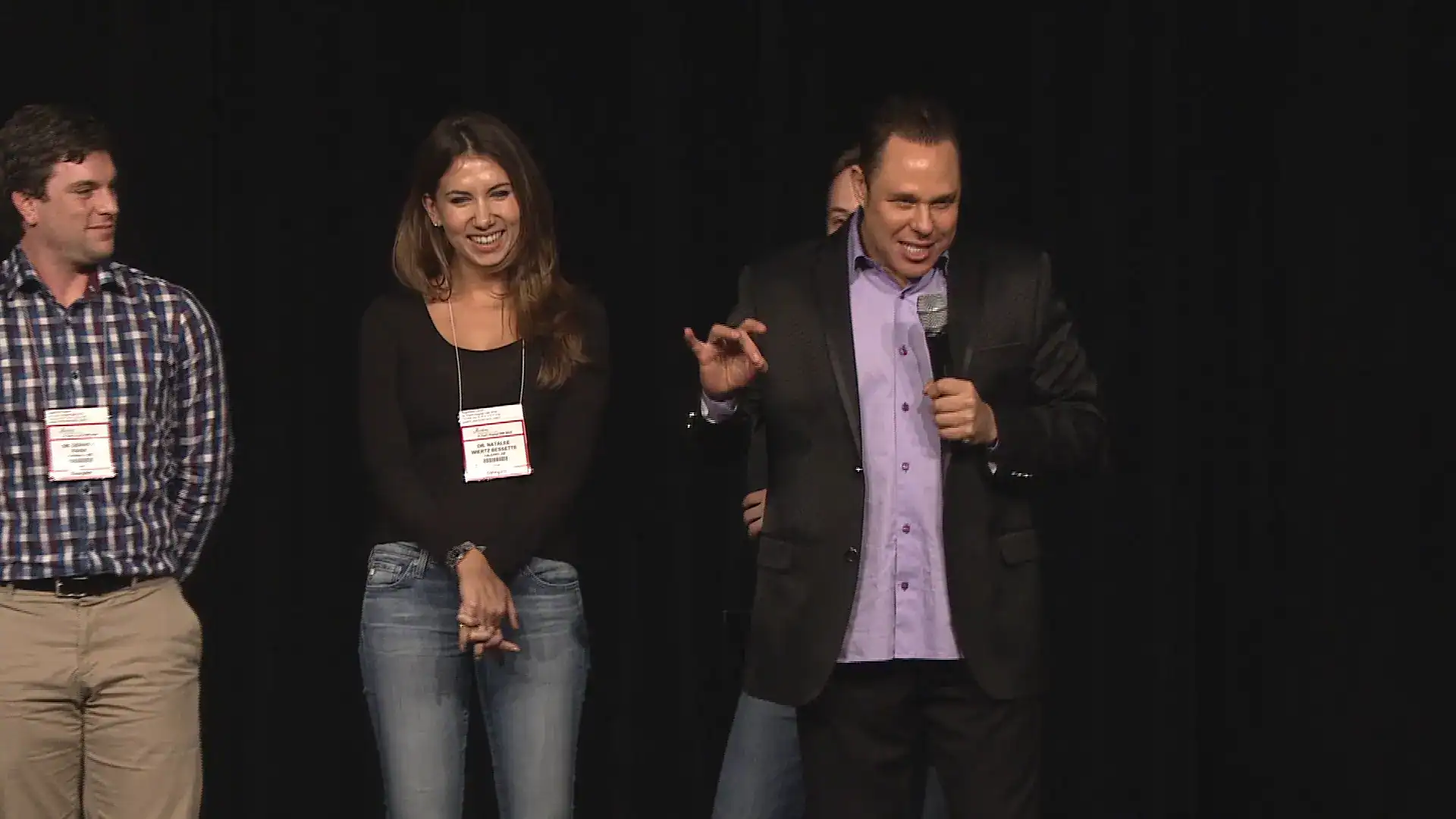 Randy Charach, magician, mentalist and comedian, interacting with audience members on stage.