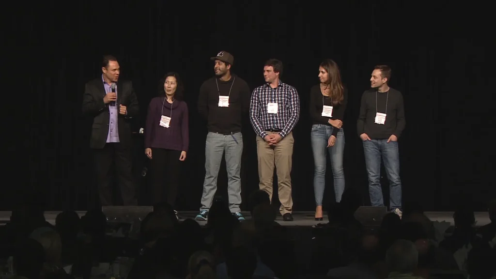 A group of people with Randy Charach on stage.