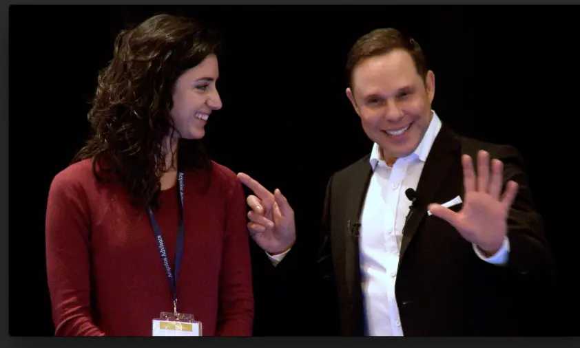 Randy Charach with an woman on stage performing.