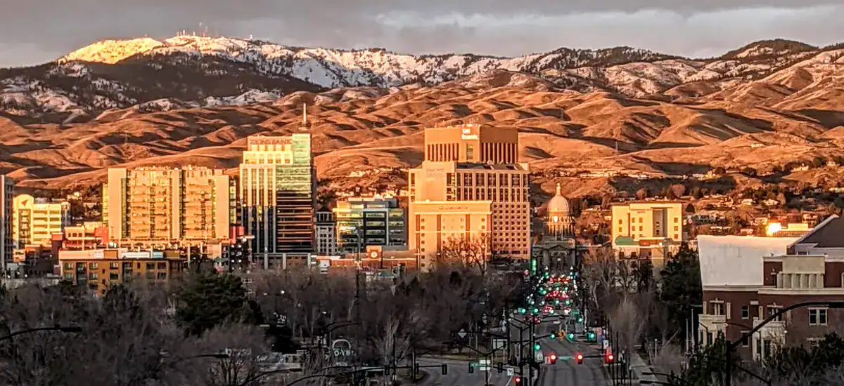 The beautiful view of Boise, Idaho, with snow-covered mountains rising behind the city.