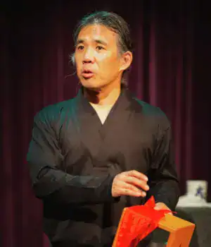 David Hirata, looking towards the audience on stage during one of his performances.