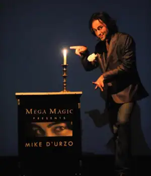 Magician Mike D'Urzo performing some act by pointing finger at candle.
